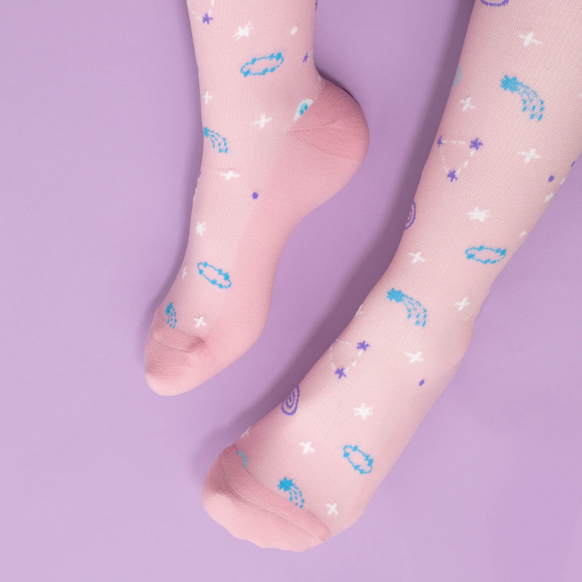 Pink compression socks with astrology pattern