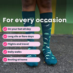 Legs close up wearing green compression socks with a dinosaur pattern