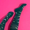 Green compression socks with a dinosaur pattern