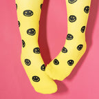 Yellow compression socks with black smiley faces