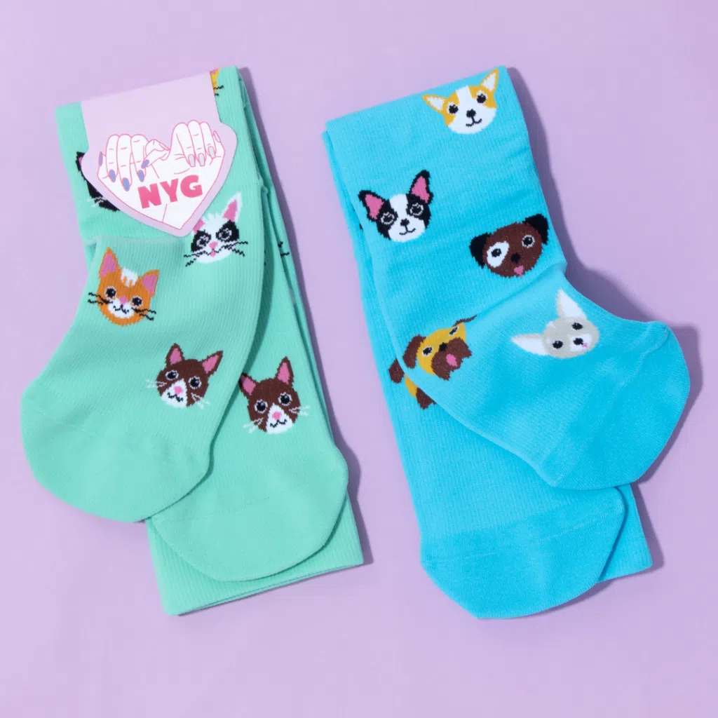 Cat and dog socks on a light purple background